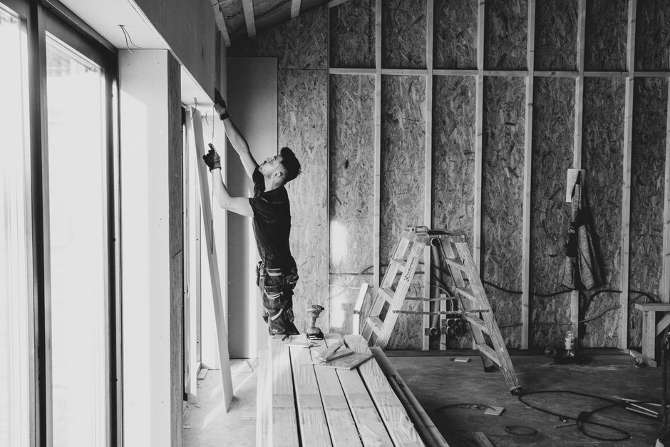 Contractor carefully installing a new double hung window